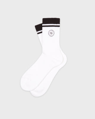 Introducing the SRHWC Socks - White/Chocolate: premium white cotton socks featuring a chocolate (black) top, chocolate stripes, and an embroidered circular logo, all wrapped in a branded white paper band. Meticulously crafted in Portugal for exceptional comfort and style.