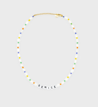 The Be Nice Pearl/Bead Necklace features colorful beads and white letter beads spelling BENICE on a gold chain. Adjustable for the perfect fit, it adds a playful accent to any outfit.