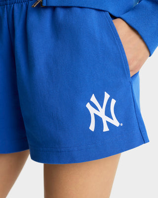 Blue shorts with a white logo on a neutral background