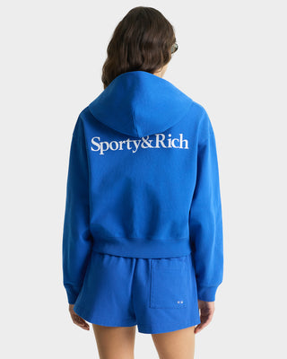 Person wearing a blue 'Sporty&Rich' hoodie and shorts on a white background