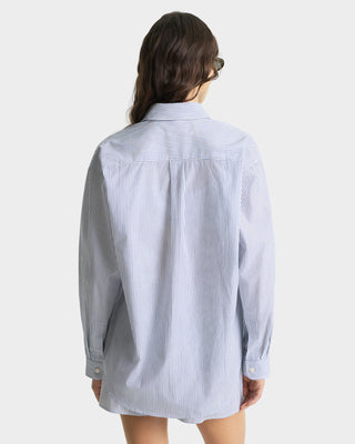 Woman wearing a blue and white striped shirt on a white background