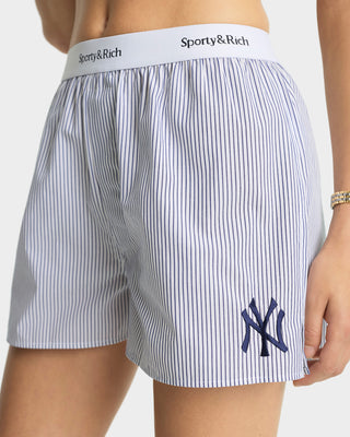 Striped shorts with Sporty & Rich waistband and New York Yankees logo on a plain background