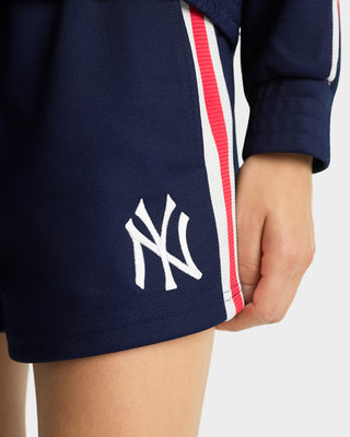 Navy shorts with a white logo on a person against a light background