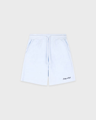 Light blue shorts with a brand logo on a beige background