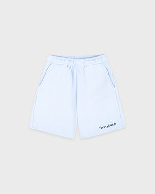 Light blue shorts with a brand logo on a beige background