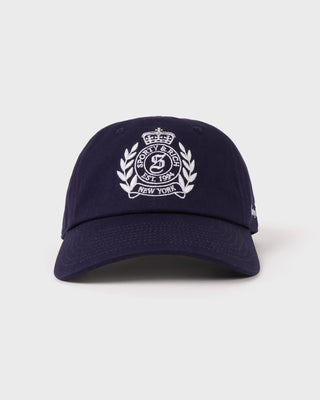 Navy blue cap with white logo on a light gray background