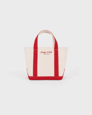 Canvas tote bag with red handles and trim on a white background