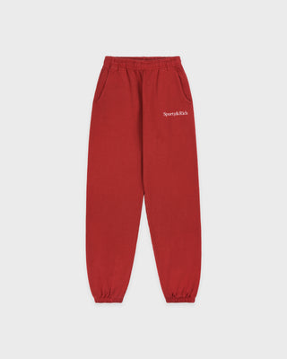 Red sweatpants with a brand logo on a white background