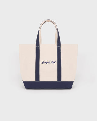 Beige tote bag with navy accents and 'Gently & Rich' branding on a white background