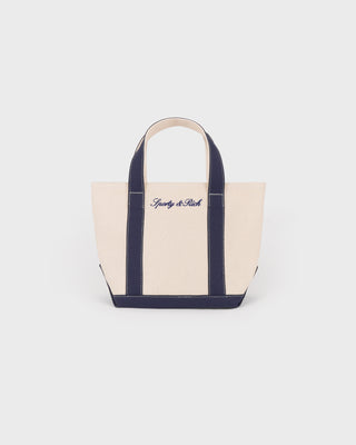 Beige tote bag with navy handles and trim on a white background