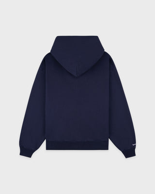 The LA Serif Zip Hoodie in Dark Navy/Navy features a zip front, LA logo on the left chest, and front pockets. Made from 100% cotton for comfort, this oversized hoodie is shown on a white background.