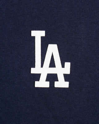 The LA Serif Zip Hoodie in Dark Navy/Navy features a zip front, LA logo on the left chest, and front pockets. Made from 100% cotton for comfort, this oversized hoodie is shown on a white background.