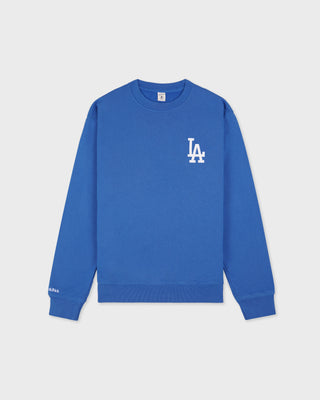LA Serif Crewneck - Team Blue/White, an oversized crewneck crafted from 100% cotton in team blue, features a white LA logo on the left chest and is displayed laid flat on a white background.