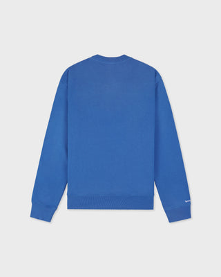 LA Serif Crewneck - Team Blue/White, an oversized crewneck crafted from 100% cotton in team blue, features a white LA logo on the left chest and is displayed laid flat on a white background.