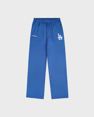 The LA Serif Wide Sweatpant in Team Blue/White features wide legs and showcases Sports Rich and LA logos on the front, crafted from soft cotton and displayed against a plain white background.