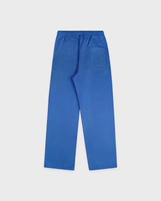 The LA Serif Wide Sweatpant in Team Blue/White features wide legs and showcases Sports Rich and LA logos on the front, crafted from soft cotton and displayed against a plain white background.