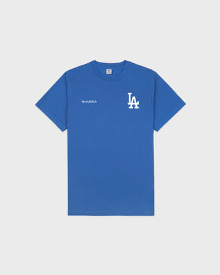 Dodgers Serif T-Shirt in Team Blue/White, featuring an LA logo and Sporty & Rich text on the front, crafted from 100% cotton for comfort, designed with an oversized fit, and shown against a plain background.