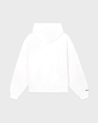 The LA Serif Zip Hoodie - White/Navy features a white zip-front design, crafted from 100% cotton, with a blue LA logo on the left chest and a front pocket, displayed against a plain background.