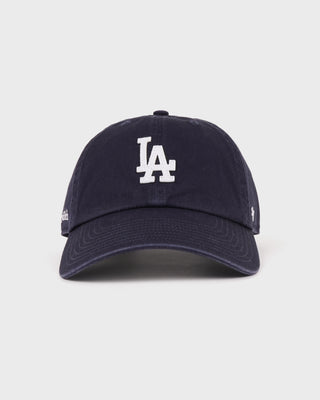 Introducing the LA Hat - Dark Navy/White: a dark navy baseball cap with a white embroidered LA logo on the front, shown against a simple backdrop and designed with an adjustable closure to ensure a comfortable fit.