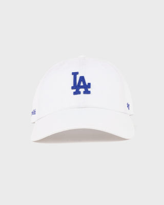 Introducing the LA Hat - White/Team Blue, a white baseball cap featuring a team blue embroidered LA logo on the front, an adjustable closure for a customized fit, and showcased against a plain white background.