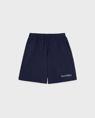 The HWCNY Gym Short in Dark Navy/White, made in the USA and crafted from 100% cotton for superior comfort and breathability, features a white Sporty & Rich print on the left leg and is displayed laid flat on a white background.