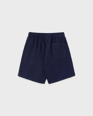 The HWCNY Gym Short in Dark Navy/White, made in the USA and crafted from 100% cotton for superior comfort and breathability, features a white Sporty & Rich print on the left leg and is displayed laid flat on a white background.