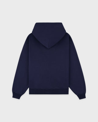 Wellness Ivy Zip Hoodie in Dark Navy/White—crafted in Portugal from 100% cotton, featuring a white WELLNESS print on the left chest and a zip-up hooded design.