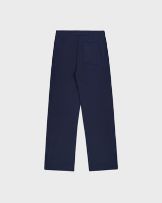 Wellness Ivy Wide Sweatpant in Dark Navy/White, featuring "WELLNESS" text on the left pocket, made from 100% cotton with an elastic waistband, displayed flat on a white background.