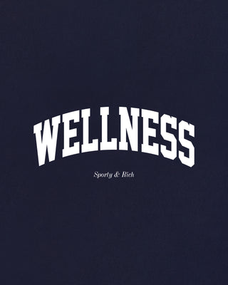 Wellness Ivy Wide Sweatpant in Dark Navy/White, featuring "WELLNESS" text on the left pocket, made from 100% cotton with an elastic waistband, displayed flat on a white background.