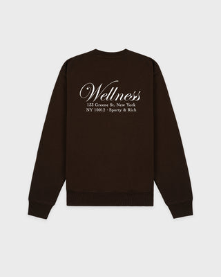 Black sweatshirt with 'Wellness' text on the back against a white background