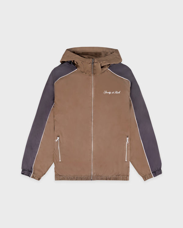 Serif Logo Gym Jacket in sand with carbon gray raglan sleeves, white piping, front zippers, and "Simply the Best" text on the chest.