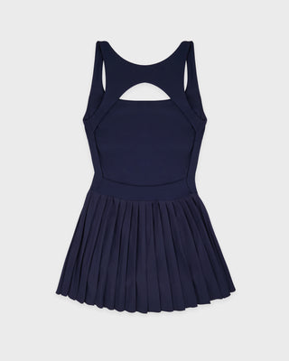 Navy blue pleated dress on a light gray background