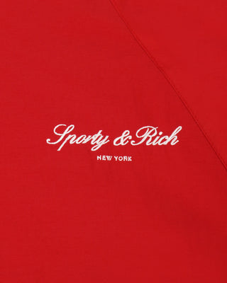 Sperry & Rich New York logo on a red background
