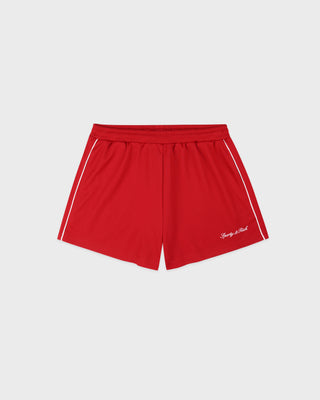 Red shorts with white piping on a light gray background