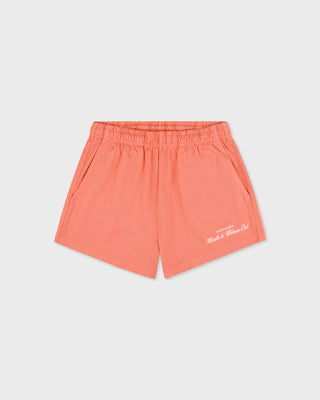Coral shorts with a brand logo on a light gray background
