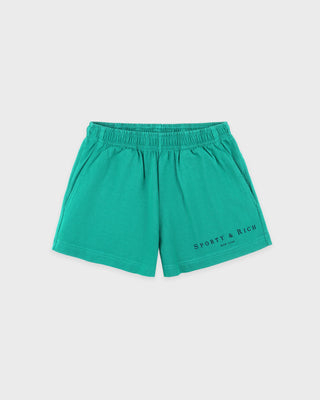 Green shorts with 'Sporty & Rich' branding on a light gray background
