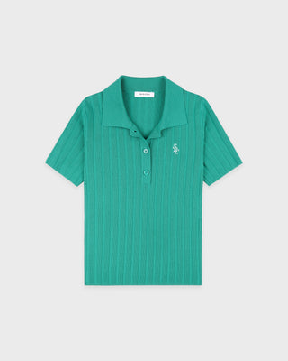 Green polo shirt on a light gray background