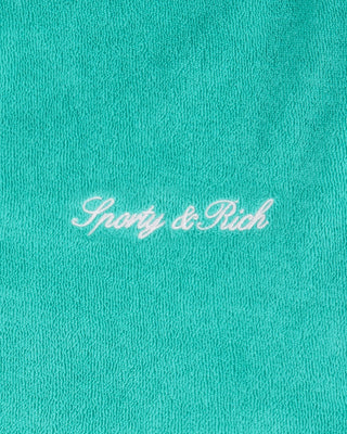 Turquoise fabric with 'Sporty & Rich' embroidery