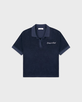 Navy blue polo shirt with brand logo on a light gray background