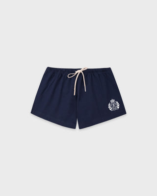 Navy blue shorts with a logo on a light gray background