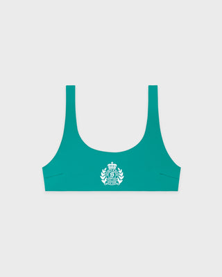 Green sports bra with a logo on a light gray background