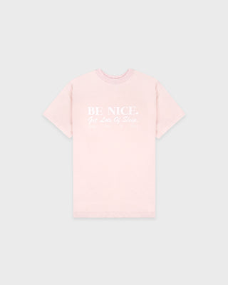 Pink t-shirt with 'BE NICE' text on a light gray background