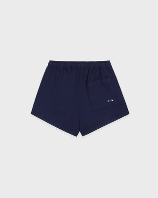 The LA Serif Disco Short in Dark Navy/White is a pair of super-short, cotton fleece shorts featuring Sports&Rich and LA logos on the front, made in the USA and displayed laid flat on a white background.