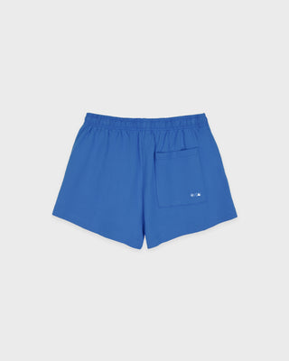 Introducing the LA Serif Disco Short in Team Blue/White—crafted from athletic cotton fleece and featuring an elastic waistband. These shorts showcase "Sports & Rich" alongside a striking white LA logo on the front, displayed laid flat against a white background. Proudly made in the USA.