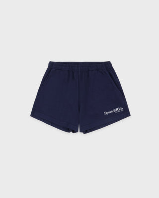 HWCNY Disco Short in Dark Navy/White is made from athletic cotton fleece, features an elastic waistband, and has the Sporty & Rich logo printed in white on the lower left leg. Made in the USA.