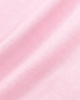The Fitness 94 Disco Short in Laffy/White features light pink cotton fleece, an elastic waistband, and a Sporty & Rich logo on the bottom right leg. Made in the USA, it is displayed on a gray background.