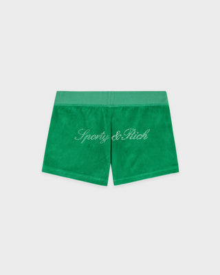Green velour shorts with a contrasting green waistband and 'Sporty & Rich' embroidered in white across the front, shown flat on a light gray background.