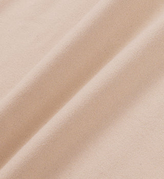 Close-up of the Stay Active Sports Bra in Elephant/White showcasing its beige fabric with soft texture and diagonal folds, emphasizing the comfort and support you expect from this premium sports bra.