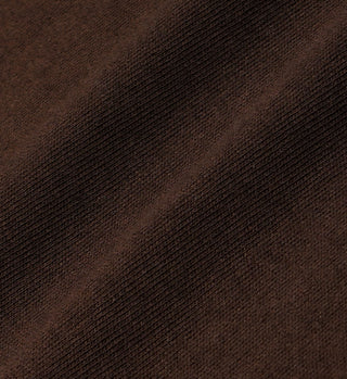 Close-up of brown, ribbed fabric with diagonal shadows highlighting the texture of the Syracuse Embroidered V-Neck Vest in Chocolate/Cream.