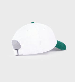 White cap with green brim on a light gray background